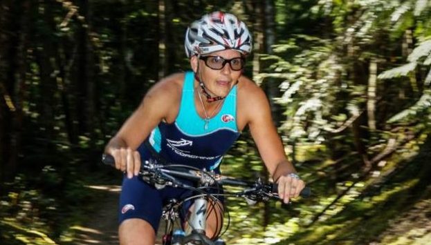 Female Competitor riding mountain bike during XTERRA Victoria triathlon on July 14th 2013