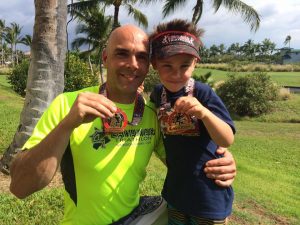 Jay Krieger and his son show off their medals at the Lavaman Triathlon in Waikoloa, Hawaii at the Lavaman Triathlon