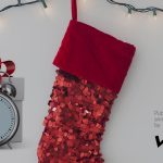 A gift of time sits beside a stocking: Happy holidays!