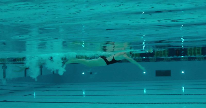 Swimmer does laps in the pool.