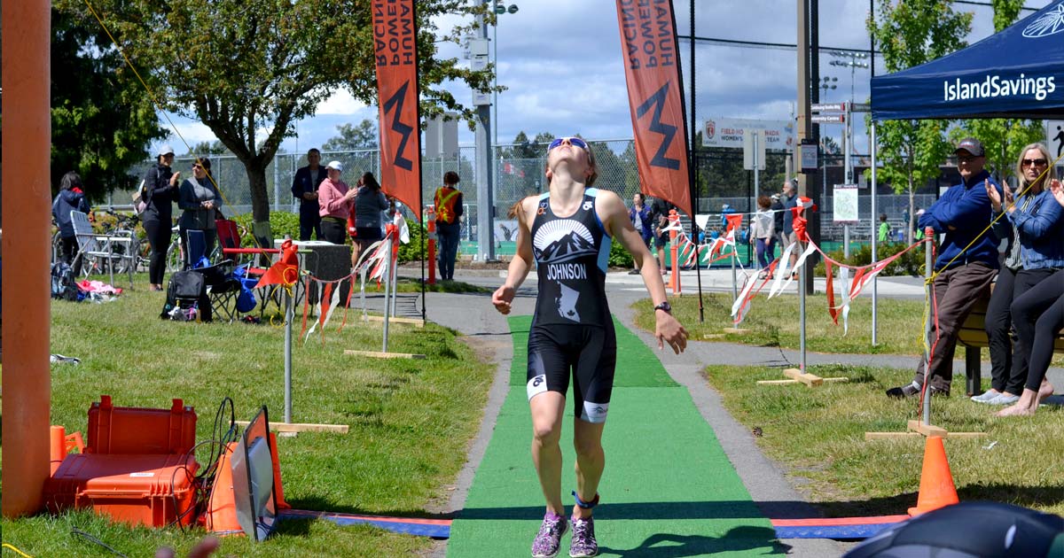 A runner makes it over the finish line at the youth triathlon at UVic.