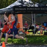 Runners in the super series take a corner right beside the Human Powered Racing tent.