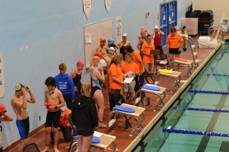 Swimmers and volunteers on deck at the McKinnon gym pool.