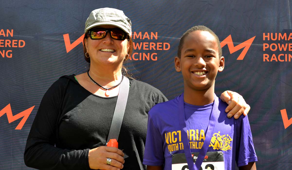 Levi Achtem and mom, Janice, stand at the podium at the Victoria Youth Triathlon.