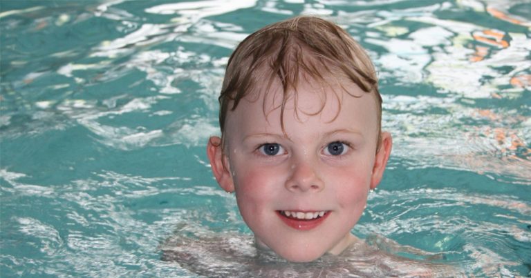 A young person treads water waiting for the next instruction at the pool.