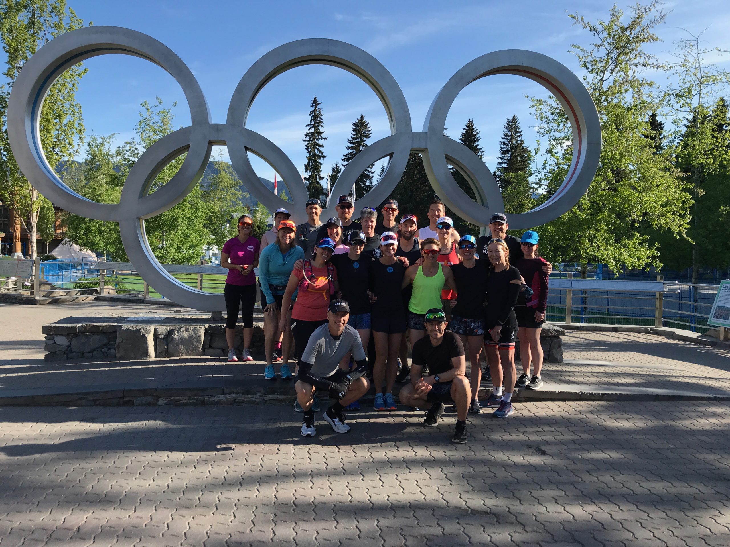 Photo of athletes in front of the Olympic Rings at Whistler Ironman Camp