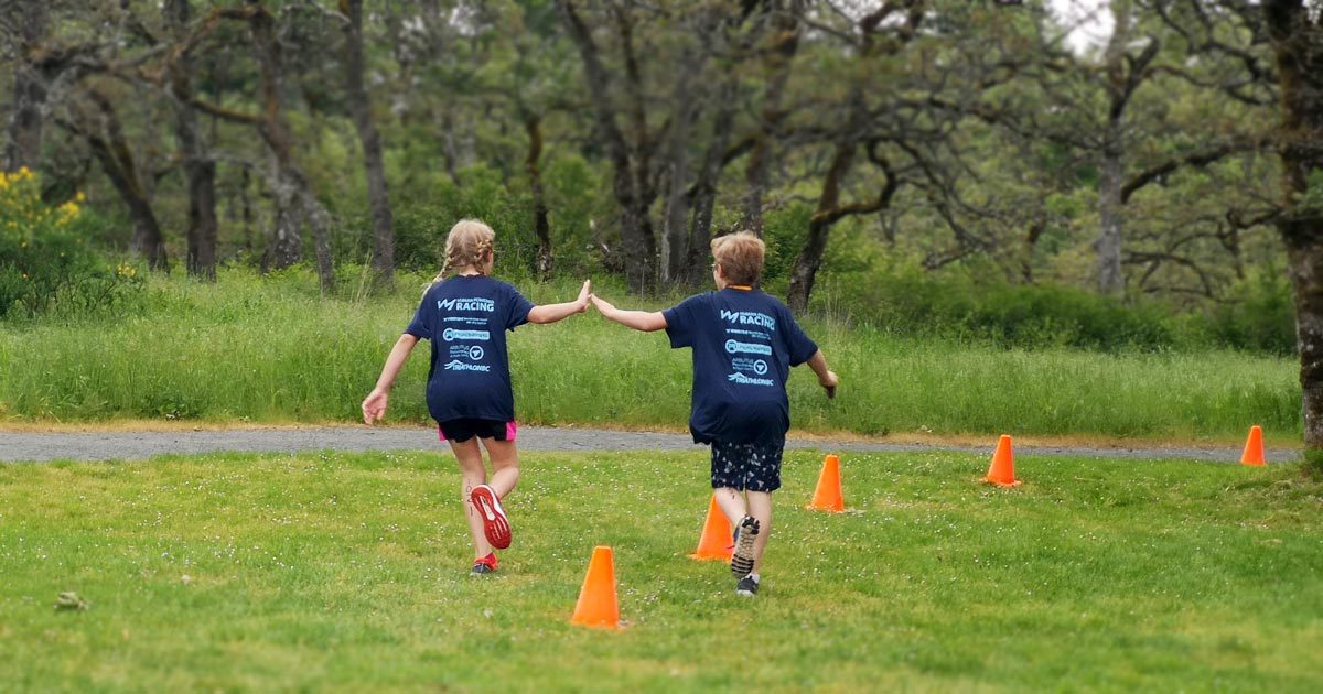 two kids high fiving as they run along at the Vic Youth Triathlon West Shore 