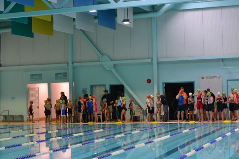 Athletes and volunteers line up along the wall at the gym to start.