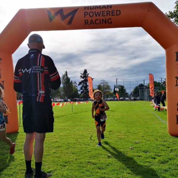 Triathlon of Compassion race finishers cross the line.