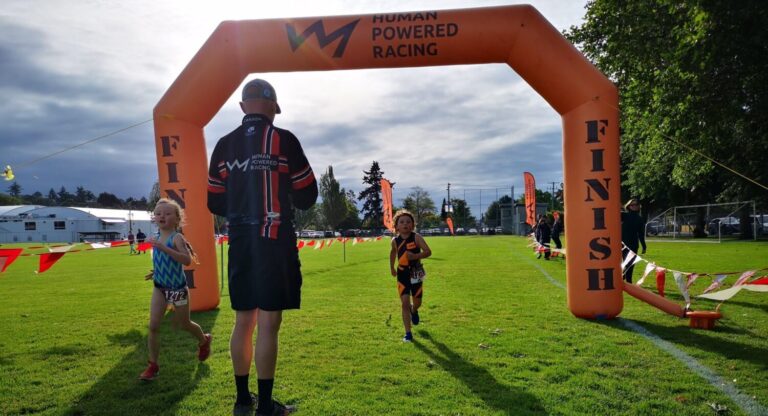 Triathlon of Compassion race finishers cross the line.