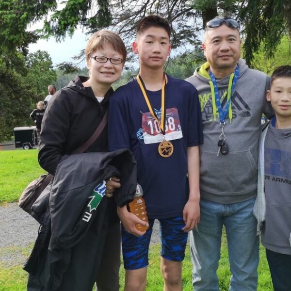 A family poses with their youth athletes.