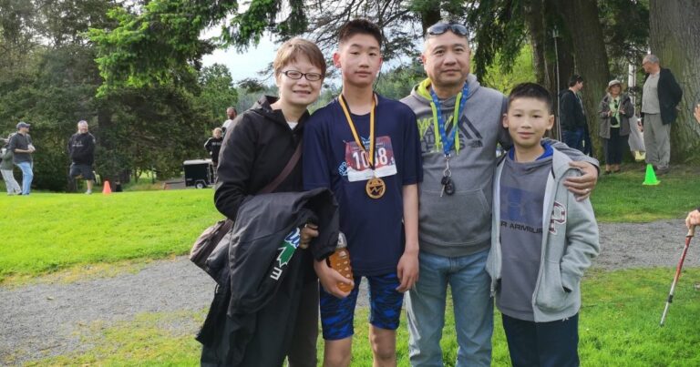 A family poses with their youth athletes.