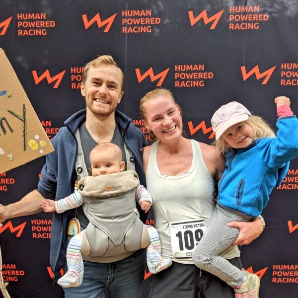 A racer and her family pose at the championship banner!
