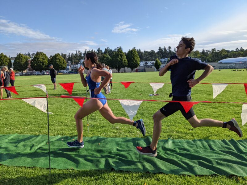 boy and girl running fast in a finishing shute