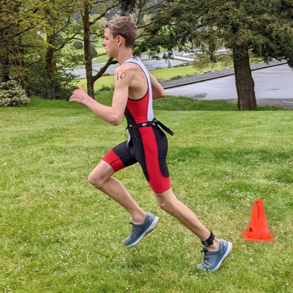 A racer takes off into the west coast forest during the run of the West Shore Youth Triathlon.