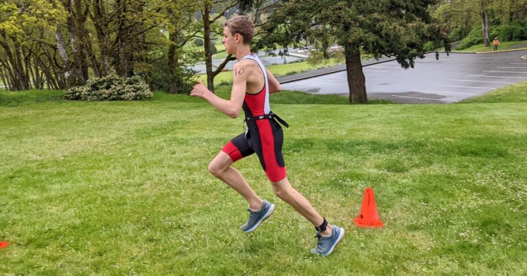 A racer takes off into the west coast forest during the run of the West Shore Youth Triathlon.