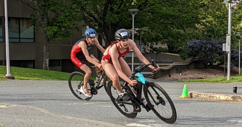 Victoria Youth Triathlon racers bank into the final stretch of the bike at UVic.