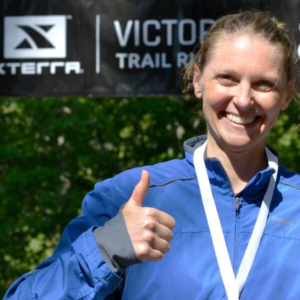 Race poses with her medal at the finish line at the XTERRA Trail Run.