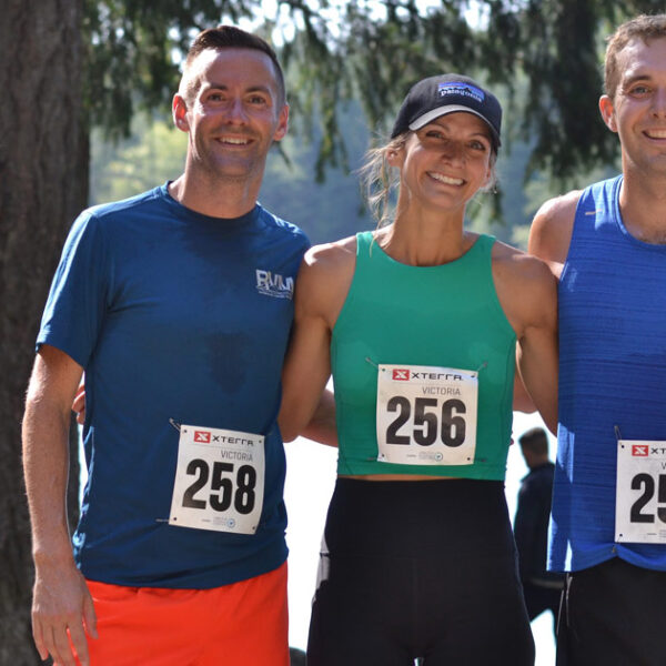 Nick, Karly, and Brandon, line up for a photo with Durrance lake in the background.