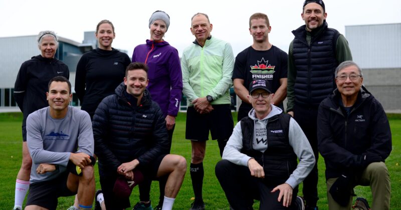 Rob and nine coaching students posing in a park