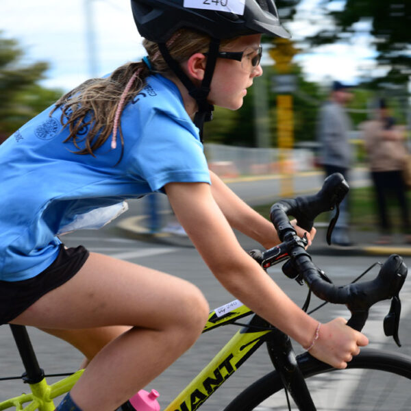 A young racer whips around the corner at the Triathlon of Compassion.