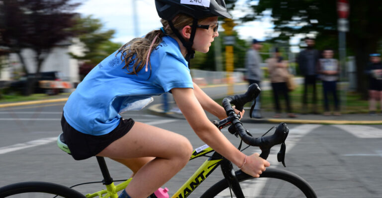 A young racer whips around the corner at the Triathlon of Compassion.
