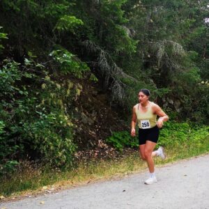 A runner comes blasting around a corner into her second lap of the trail run.